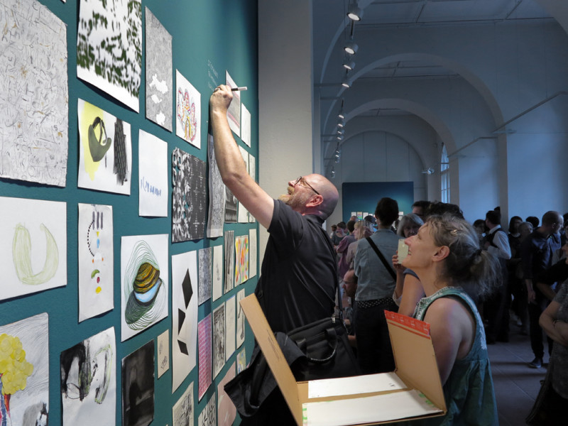 Visitors interact with the exhibition.