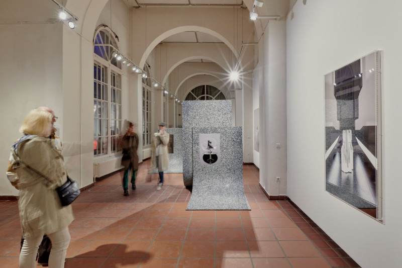 Interior of the Galerie im Körnerpark with visitors, sculptures on the floor, and artworks on the walls