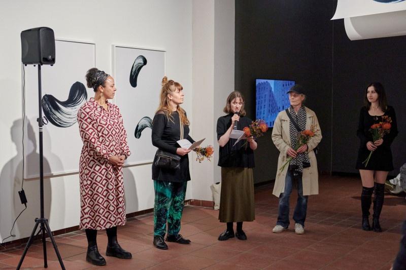 Speech with a group of five women in the gallery space