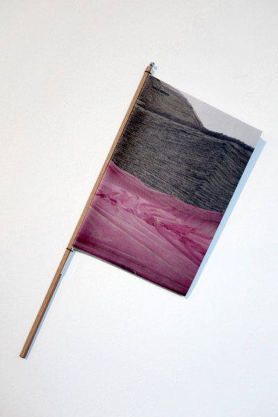 Magazine TIEMPO MUERTO (Dead Time) tied around a stick and attached to the wall for viewing