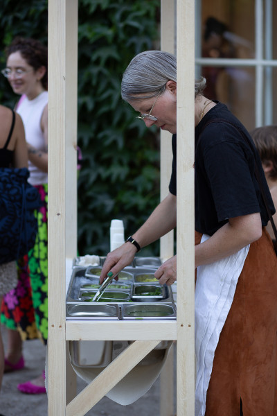 Artist Eva-Fiore Kovacovsky serving wild plant sorbet ath the opening