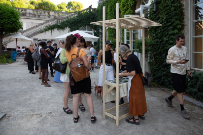 Artist Eva-Fiore Kovacovsky serving wild plant sorbet at the opening