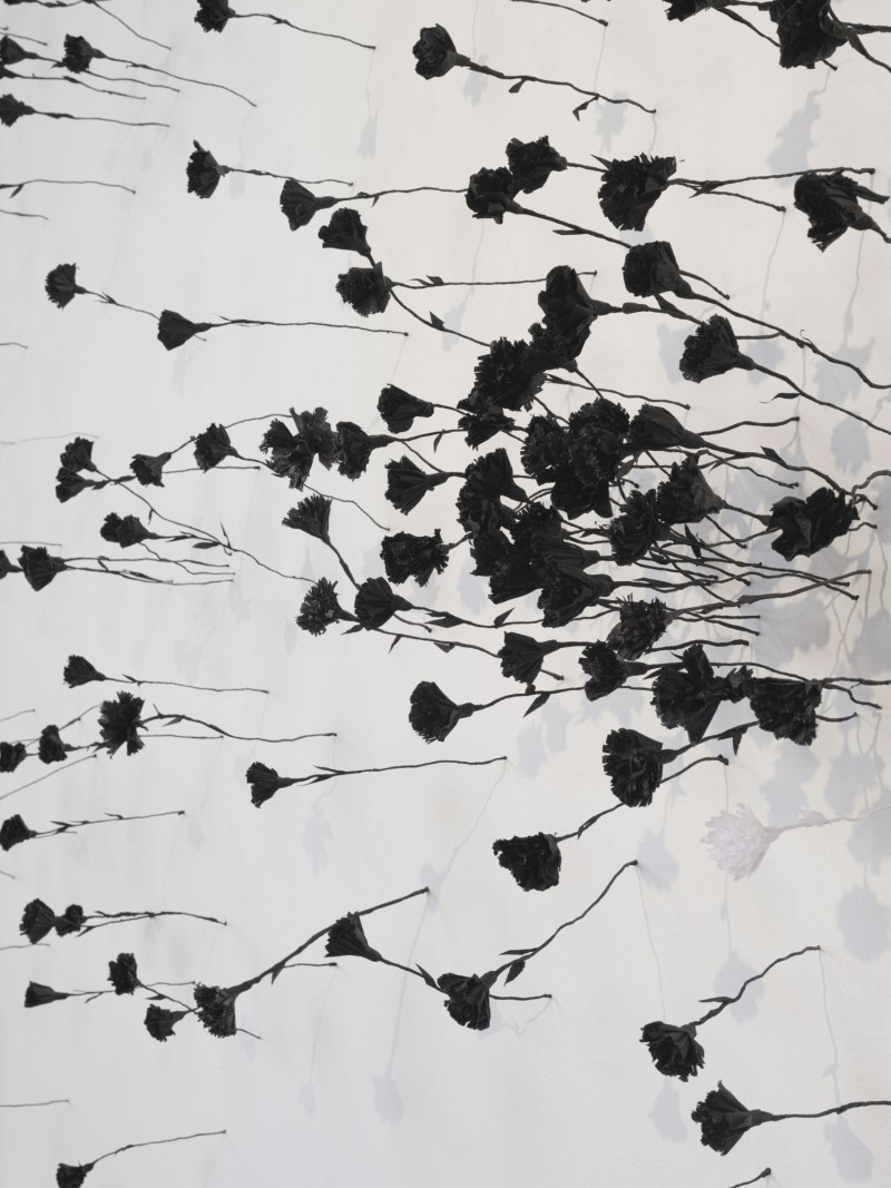 Detailaufnahme von der Wandinstallation mit Blumen aus Krepppapier und Draht von der Künstlerin Rozalina Buse