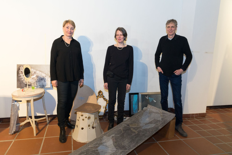 The artists in the exhibition stand in the middle of an installation.