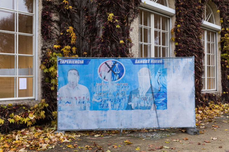 Ein kaputtes altes blaues Wahlplakat steht draußen vor der Galerie.