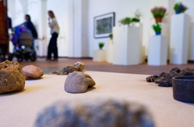 Close-up of ceramic objects and lumps of earth placed on a block