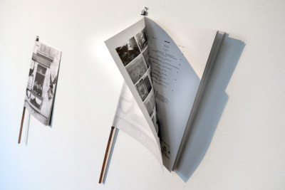 Two magazines are hanging on a wall.