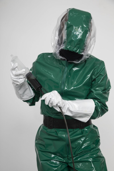 A person in a green suit is doing maintenance work.